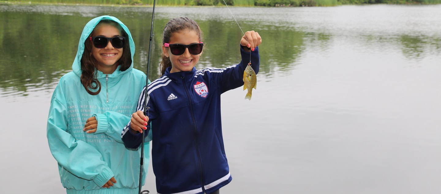 young girls enjoy fishing at Heart Lake